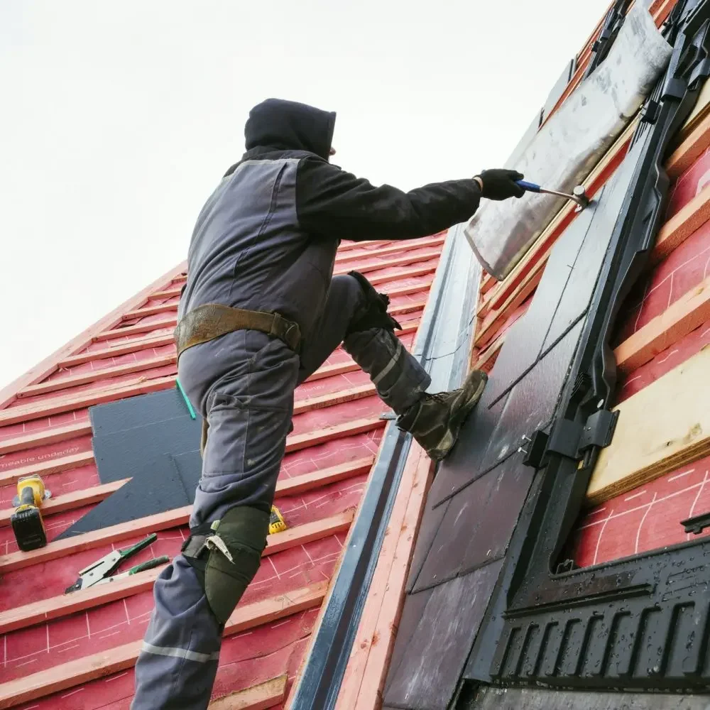 a-roofer-replacing-the-tiles-on-a-house-roof--qfsf4qk6d9236r39ppzulgxug7eceama8bd9kyqlg0