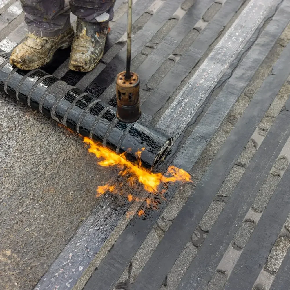 Bituminous membrane waterproofing system details and installation on flat rooftop.